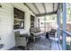Comfortable screened porch with cushioned seating, wicker chairs, and a decorated rug for outdoor relaxation at 5736 Primrose Ave, Indianapolis, IN 46220