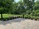 Enjoyable backyard showcasing a stone patio, garden boxes, and meticulous landscaping for ideal outdoor living at 5775 Coopers Hawk Dr, Carmel, IN 46033
