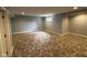 Finished basement area with durable carpet and a window for natural light at 5775 Coopers Hawk Dr, Carmel, IN 46033