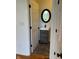 Charming powder room with a dark vanity, a decorative mirror, and modern fixtures at 5775 Coopers Hawk Dr, Carmel, IN 46033