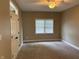 Cozy bedroom featuring carpeted floors, a ceiling fan, and a window for natural light at 5775 Coopers Hawk Dr, Carmel, IN 46033