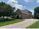 Beautiful brick home showcasing a three-car garage and spacious driveway at 5775 Coopers Hawk Dr, Carmel, IN 46033