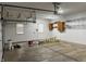 Spacious garage with windows, storage cabinets, shelving, and an opener, perfect for parking and projects at 5775 Coopers Hawk Dr, Carmel, IN 46033