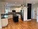 Modern kitchen featuring granite countertops, stainless steel appliances, and a black island at 5775 Coopers Hawk Dr, Carmel, IN 46033