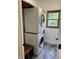 Stacked washer and dryer in laundry room with tile floor and a window offering natural light at 5775 Coopers Hawk Dr, Carmel, IN 46033