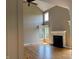 Spacious living room with a fireplace, hardwood floors, and lots of natural light at 5775 Coopers Hawk Dr, Carmel, IN 46033