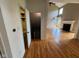 Open-concept view of the living room featuring a fireplace, hardwood floors, and access to powder room at 5775 Coopers Hawk Dr, Carmel, IN 46033