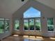 Spacious living room with vaulted ceilings, hardwood floors, and many windows offering natural light and beautiful views at 5775 Coopers Hawk Dr, Carmel, IN 46033