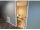 Efficient powder room with a classic toilet, sink, and tile flooring as seen through open doorway at 5775 Coopers Hawk Dr, Carmel, IN 46033