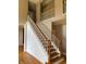 Detailed view of the staircase with wood accents, connecting both floors of the home at 5775 Coopers Hawk Dr, Carmel, IN 46033