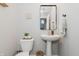 Charming powder room featuring a pedestal sink, elegant mirror, and stylish decor at 5809 Terracotta Trce, McCordsville, IN 46055