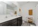 Clean bathroom featuring a double vanity, wood look floors, and stylish orange accents at 5809 Terracotta Trce, McCordsville, IN 46055