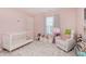 Bright Bedroom with a white crib, comfortable rocking chair, and a plush floral rug at 5809 Terracotta Trce, McCordsville, IN 46055