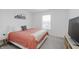 Cozy bedroom with a queen bed, soft carpet, and bright natural light from the window at 5809 Terracotta Trce, McCordsville, IN 46055