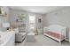 Inviting Bedroom with gray walls, a white crib, comfortable chair and book ledges at 5809 Terracotta Trce, McCordsville, IN 46055