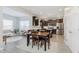 Open-concept dining area with a wooden table set, seamlessly connected to the kitchen and living room at 5809 Terracotta Trce, McCordsville, IN 46055