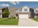 Charming two-story home with a brick and siding exterior, well-maintained lawn, and an attached two-car garage at 5809 Terracotta Trce, McCordsville, IN 46055