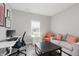 Cozy living room with neutral tones, desk space, comfortable seating, and abundant natural light at 5809 Terracotta Trce, McCordsville, IN 46055