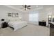 Bright main bedroom with ceiling fan, neutral carpet, tray ceiling, and decorative shelving at 5809 Terracotta Trce, McCordsville, IN 46055