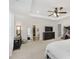 Spacious main bedroom features tray ceiling, neutral carpet, ceiling fan, and access to ensuite at 5809 Terracotta Trce, McCordsville, IN 46055