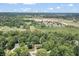 A high altitude view showcasing the home's neighborhood location and abundance of surrounding trees at 604 Oak Blvd W Dr, Greenfield, IN 46140