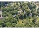 Overhead shot of the property revealing its proximity to neighborhood streets and lush, mature trees at 604 Oak Blvd W Dr, Greenfield, IN 46140