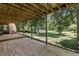 View from underneath a wood deck overlooking a large, fenced backyard at 604 Oak Blvd W Dr, Greenfield, IN 46140