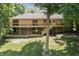 Spacious brick home with a large deck and stairs leading to the expansive backyard at 604 Oak Blvd W Dr, Greenfield, IN 46140