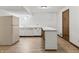 Basement kitchenette area with white cabinets and countertops, creating a convenient and functional space at 604 Oak Blvd W Dr, Greenfield, IN 46140
