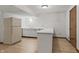 Basement featuring a kitchenette area with white cabinets and countertops, offering extra convenience at 604 Oak Blvd W Dr, Greenfield, IN 46140