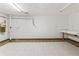 Unfinished basement area with tiled floor and work table at 604 Oak Blvd W Dr, Greenfield, IN 46140