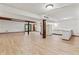 Bright basement with kitchenette area, hardwood floors, and natural light, great for gatherings at 604 Oak Blvd W Dr, Greenfield, IN 46140