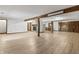Open basement area with fireplace, wood-look floors, offering versatile living space for relaxation at 604 Oak Blvd W Dr, Greenfield, IN 46140