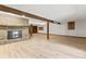 Spacious basement area with fireplace, wood beams, and hardwood floors, perfect for entertaining at 604 Oak Blvd W Dr, Greenfield, IN 46140