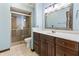 Bathroom with a tiled shower, updated vanity, and decorative mirror at 604 Oak Blvd W Dr, Greenfield, IN 46140