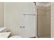 Bathroom featuring wallpaper and a shower with silver trim, offering a glimpse of functionality at 604 Oak Blvd W Dr, Greenfield, IN 46140