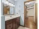Bathroom featuring a vanity, mirror, lighting, and doorway to the living room at 604 Oak Blvd W Dr, Greenfield, IN 46140