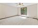 A well-lit bedroom featuring neutral walls, carpet and a ceiling fan at 604 Oak Blvd W Dr, Greenfield, IN 46140