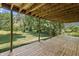 View from the wooden deck overlooking a large, well-maintained lawn and lush greenery at 604 Oak Blvd W Dr, Greenfield, IN 46140
