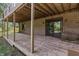 Under-deck area of a brick home, featuring a wood deck and access to backyard at 604 Oak Blvd W Dr, Greenfield, IN 46140