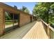 Spacious wood deck overlooking a private, wooded backyard, accessible via sliding glass doors at 604 Oak Blvd W Dr, Greenfield, IN 46140