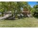 Charming brick home with mature trees, manicured landscaping, and a two-car garage at 604 Oak Blvd W Dr, Greenfield, IN 46140