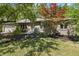 Charming brick home with mature trees, manicured landscaping, and an attached two-car garage at 604 Oak Blvd W Dr, Greenfield, IN 46140