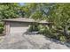 Charming brick home with a two-car garage, mature trees, and established landscaping at 604 Oak Blvd W Dr, Greenfield, IN 46140