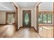 Foyer features a decorative front door, tiled flooring, and adjoining rooms with hardwood floors at 604 Oak Blvd W Dr, Greenfield, IN 46140