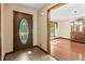 Home's inviting front entry boasts a decorative door and tiled floor leading to the dining room at 604 Oak Blvd W Dr, Greenfield, IN 46140