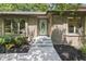 Brick home entrance with an oval window door, concrete steps, and dark mulch landscaping at 604 Oak Blvd W Dr, Greenfield, IN 46140