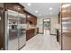 Spacious kitchen featuring stainless steel appliances, granite countertops, and tiled floors at 604 Oak Blvd W Dr, Greenfield, IN 46140