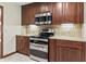 Gourmet kitchen showcasing stainless steel appliances and custom wood cabinetry at 604 Oak Blvd W Dr, Greenfield, IN 46140