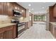 Beautiful kitchen showcasing stainless steel appliances, granite countertops, and tiled floors at 604 Oak Blvd W Dr, Greenfield, IN 46140